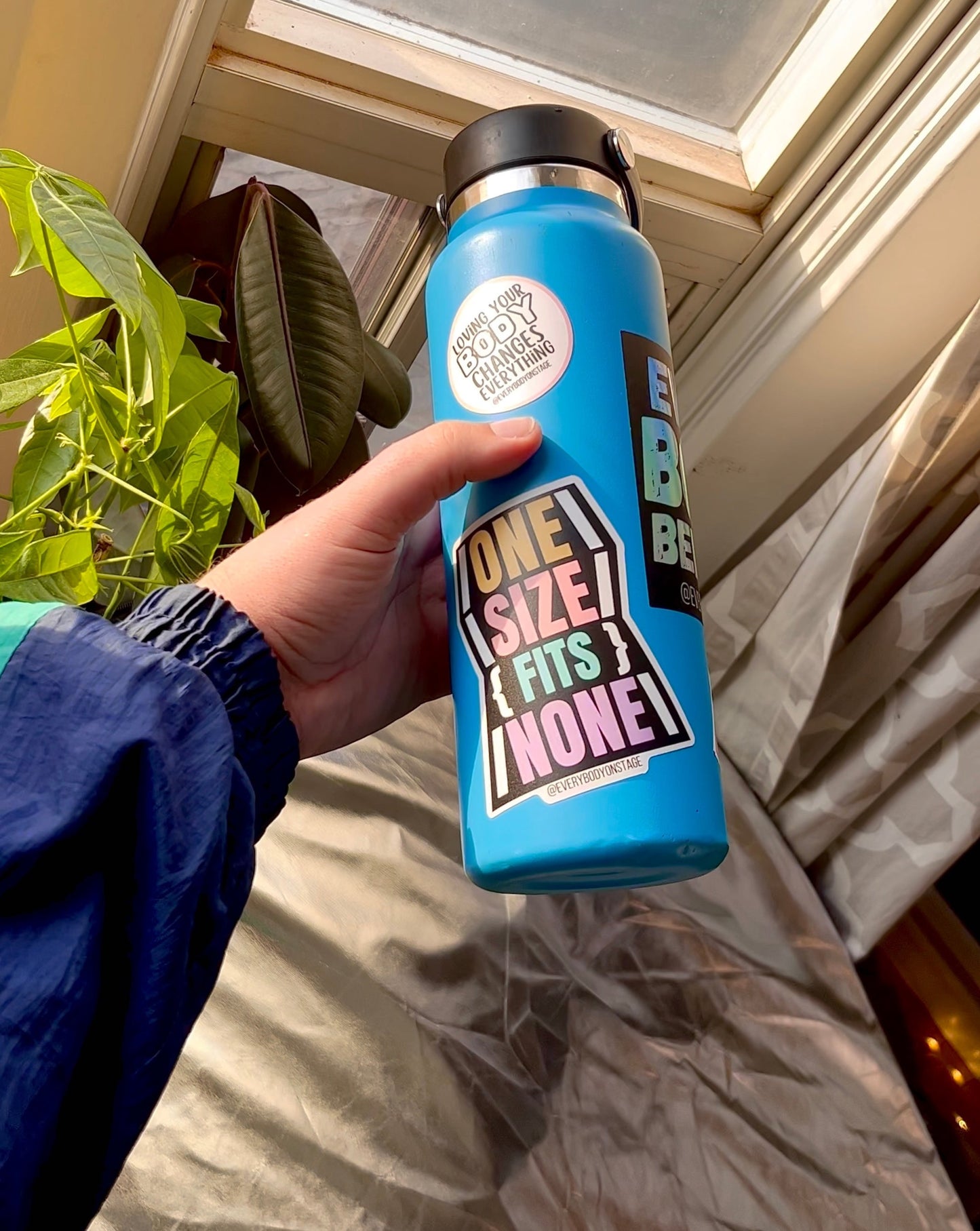 A blue water bottle with the sticker collection